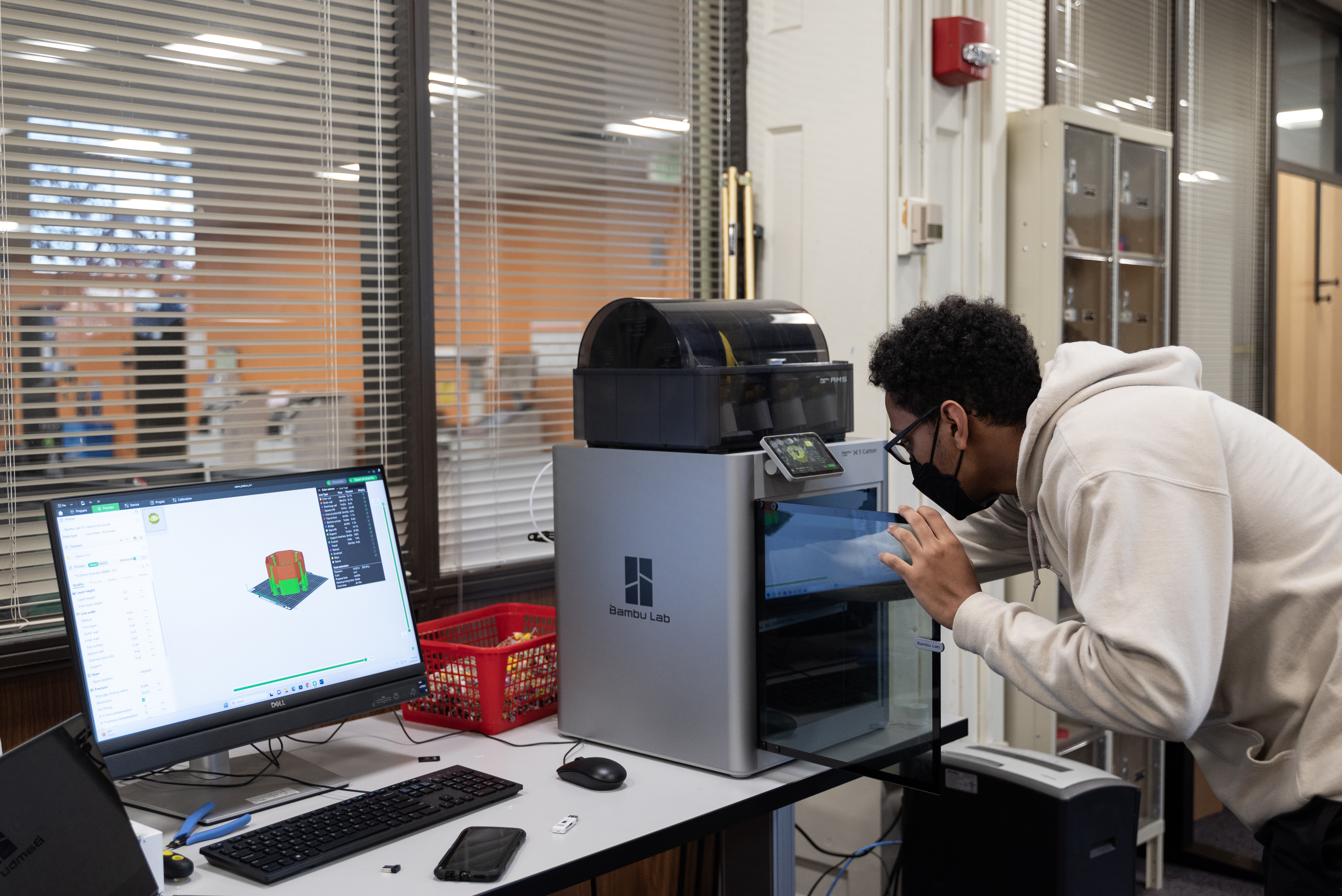 Patron setting up 3D print on Bambu Lab X1 Carbon 3D printer.