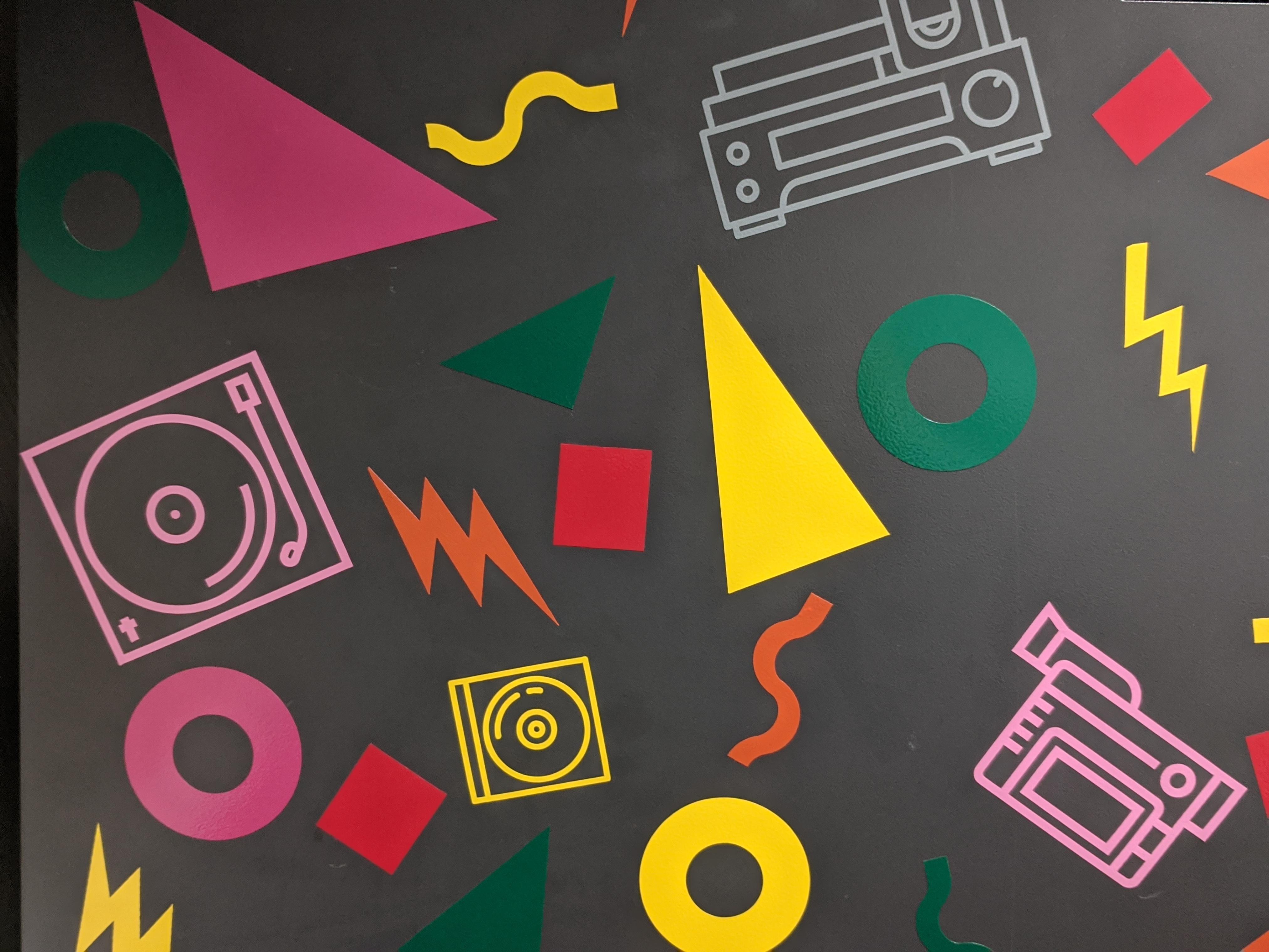 Stickers in a decorative design combining colorful shapes with media-related images such as a camera, CD, vinyl record player, etc.
