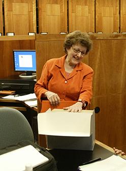 Bonnie Joe Dopp Hurley putting files in a file folder.