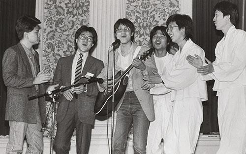 Korean men sing and play music at an East Asian party