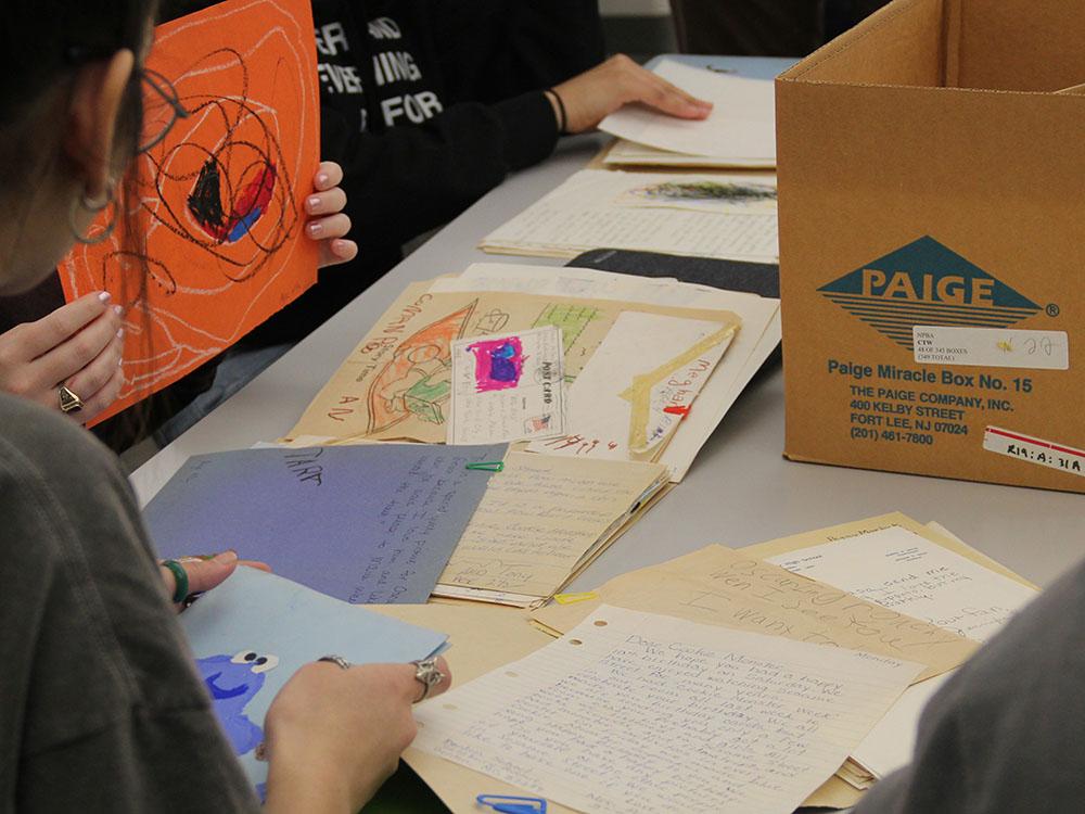 Students using archival material during an instruction session in Hornbake Library