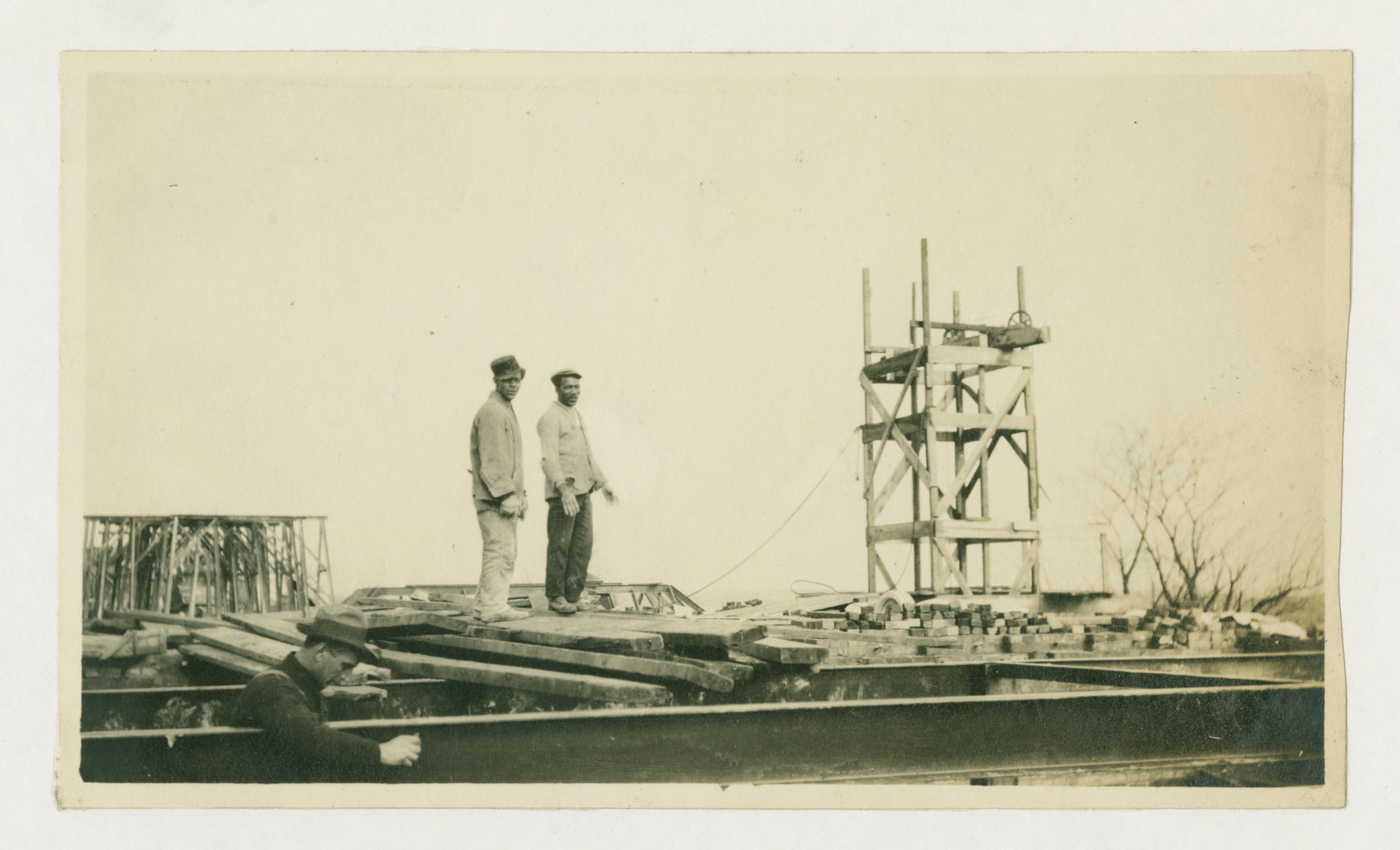 Calvert Hall under construction with two black men pictured.