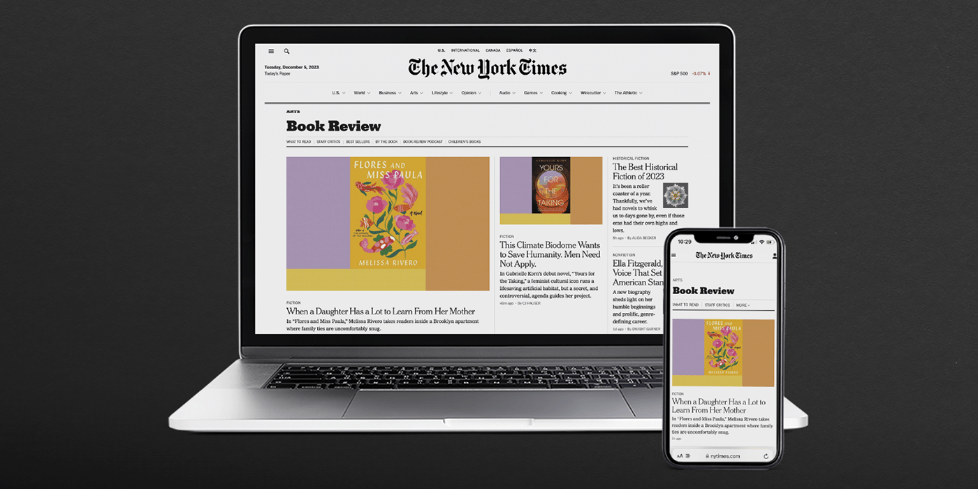 Laptop and smartphone screens showing the New York Times Website on a black background.