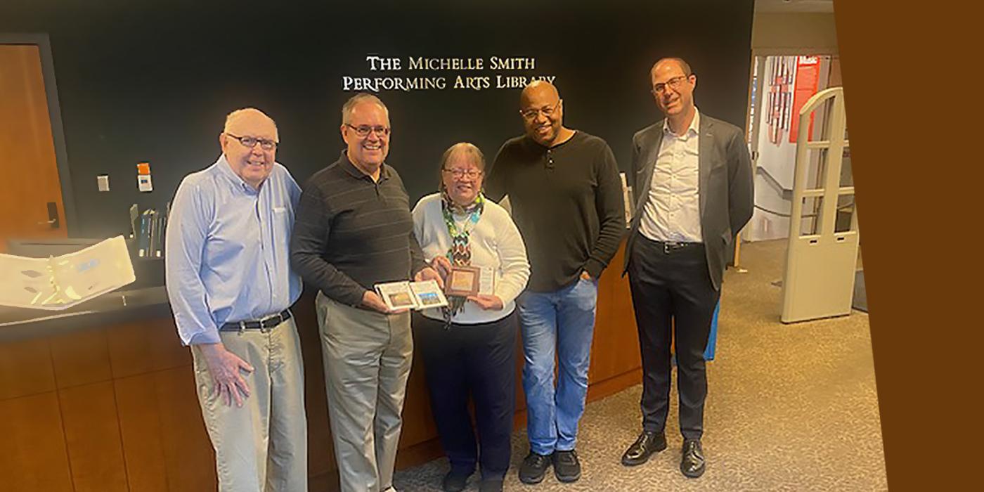 Five people at the Michelle Smith Performing Arts Library including JoAnne Barry ’89 and Ken Boulton ’86.