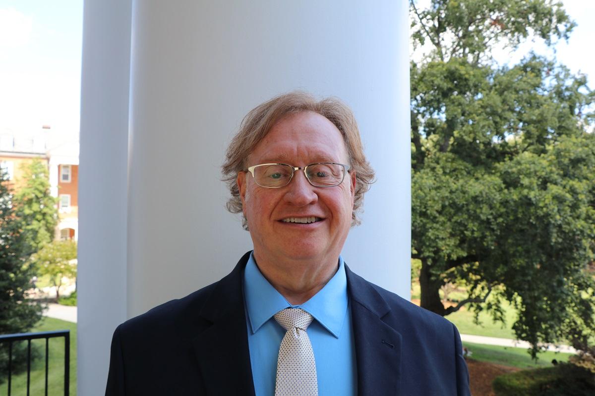 Dan Mack, Interim Dean of UMD Libraries, stands in front of a column on the portico