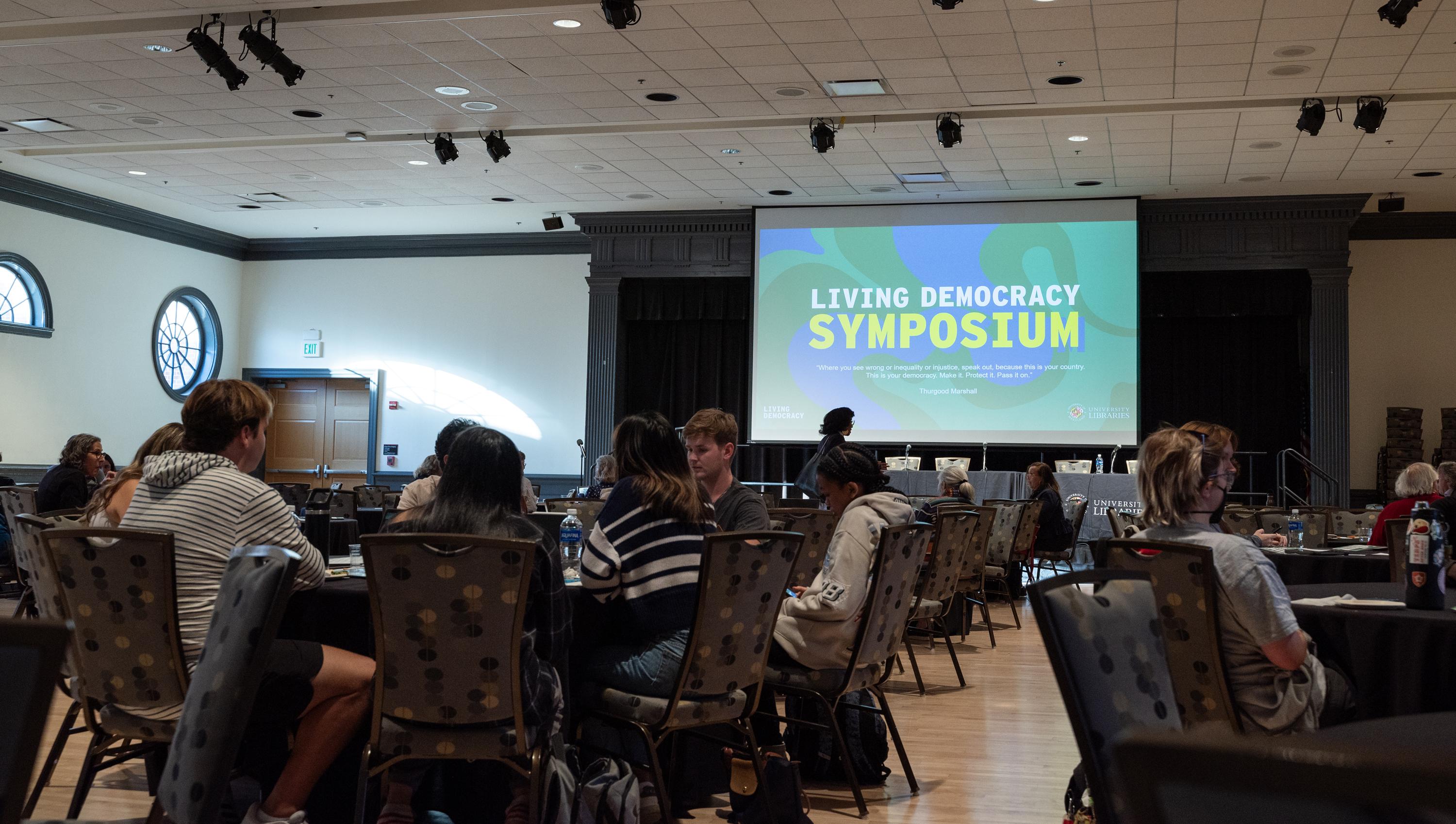 Students at a table during the Living Democracy Symposium.