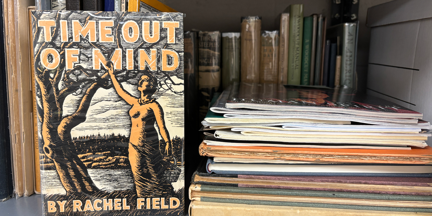 Books and papers on a shelf.