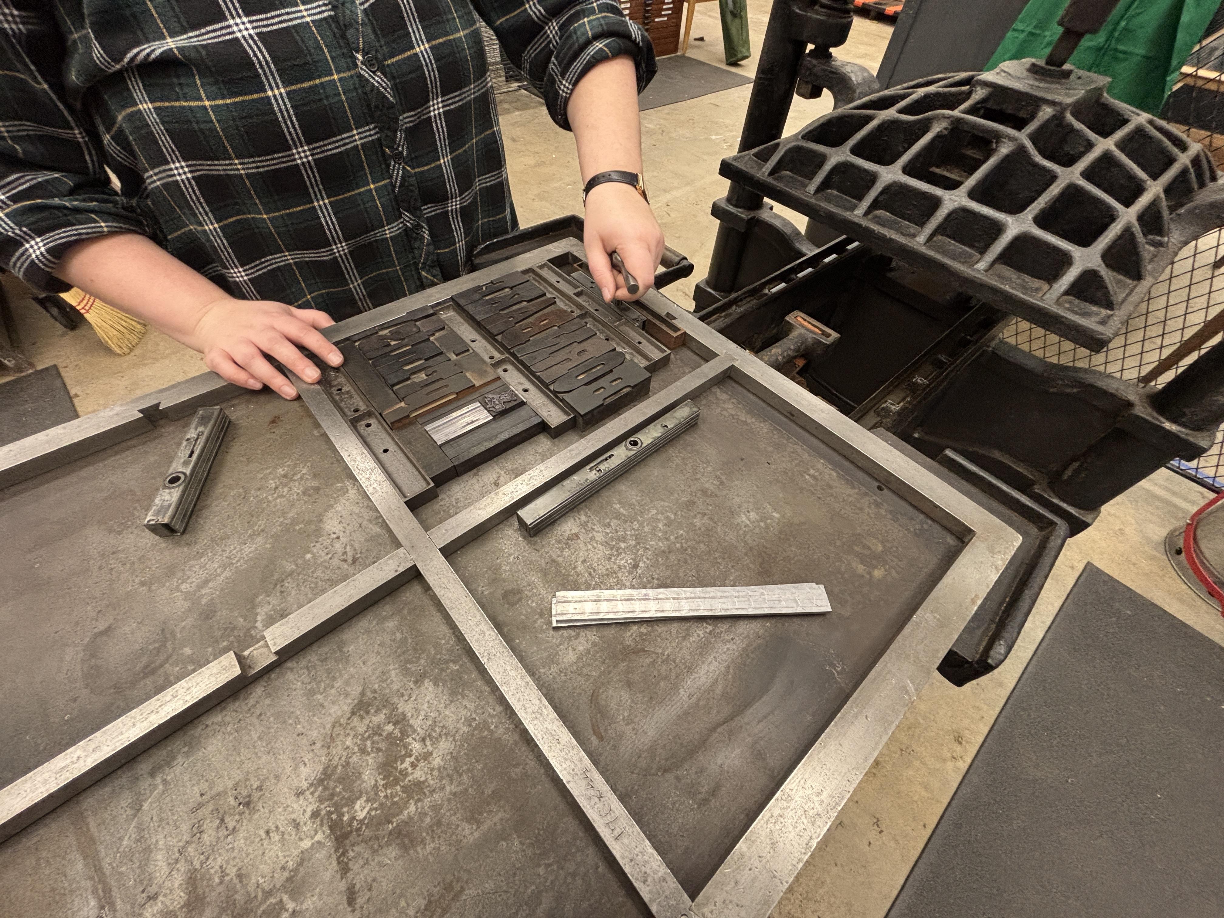 Locking up a form in the Hornbake Library Letterpress Studio