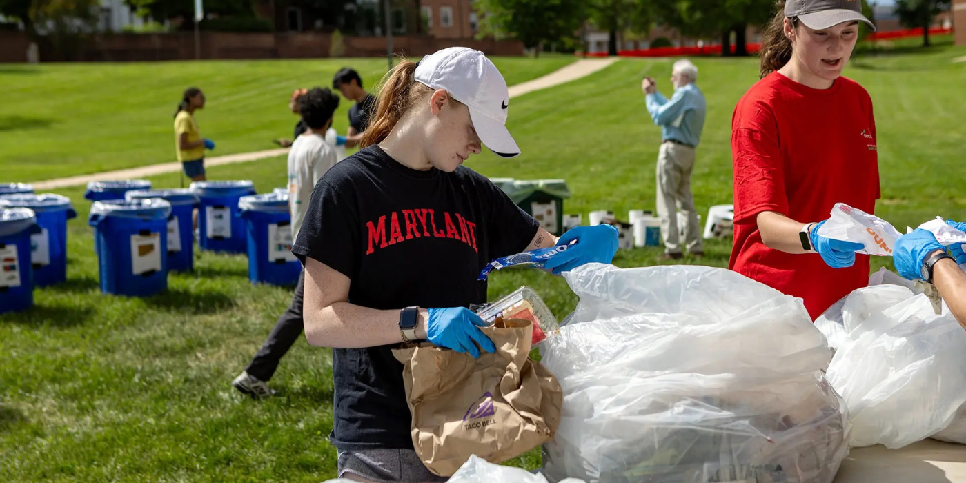 Students sorting waste behind McKeldin Library.