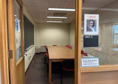 Sign with George Washington Carver photo is displayed on window next to open door leading into the room