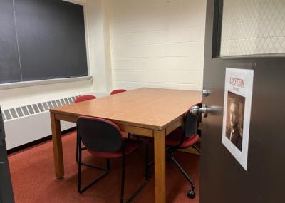 Sign with Albert Einstein photo is displayed on open door leading into the room