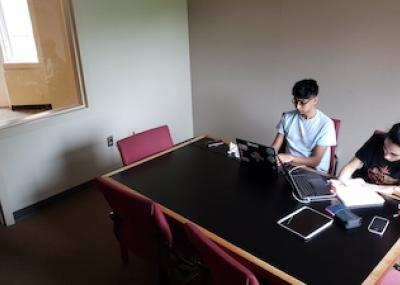 Room with window, wooden table, and six chairs 